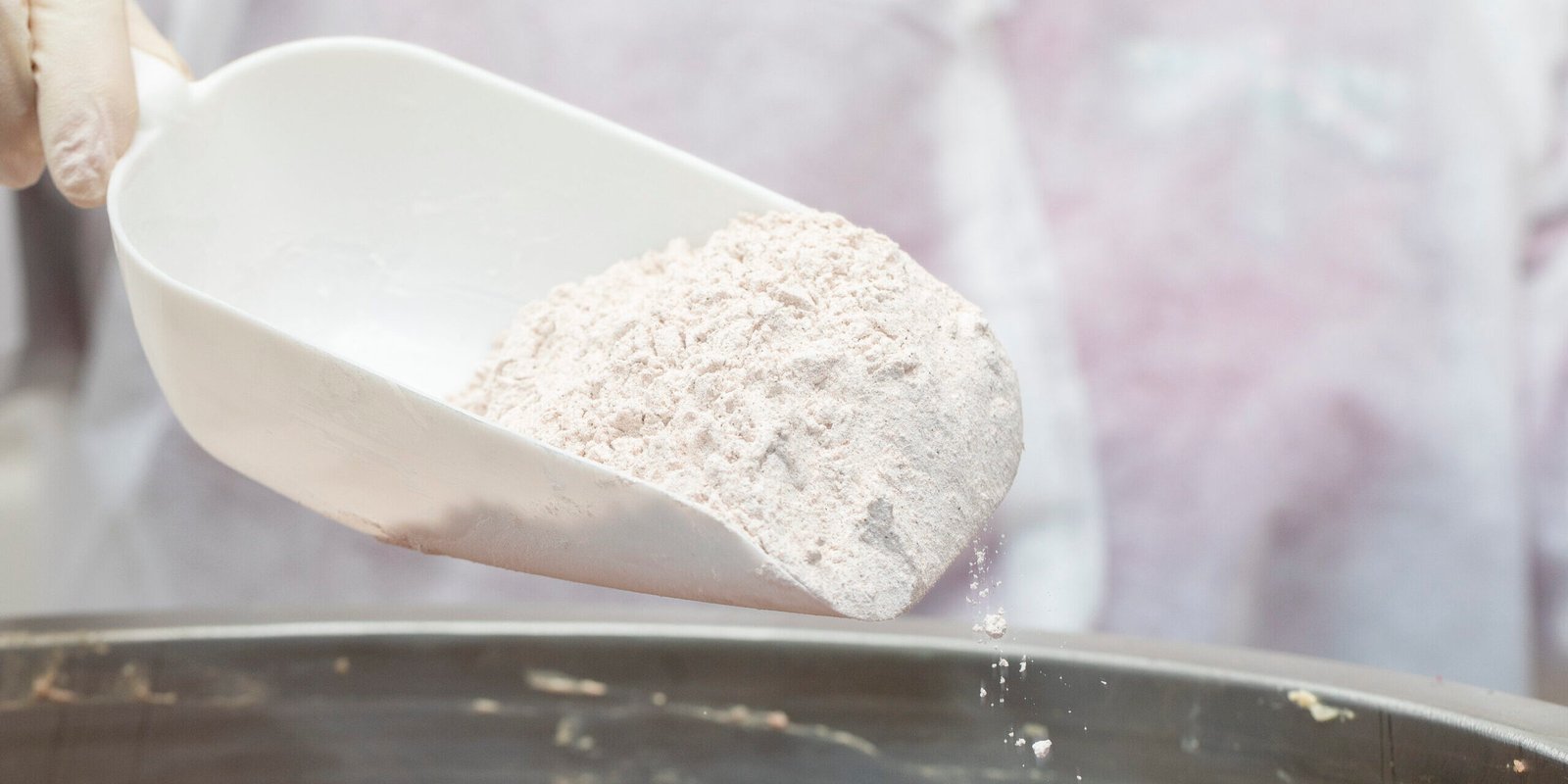 Adding flour into frying metallic pan