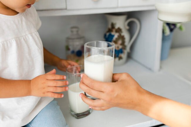 mother-hand-offering-glass-milk