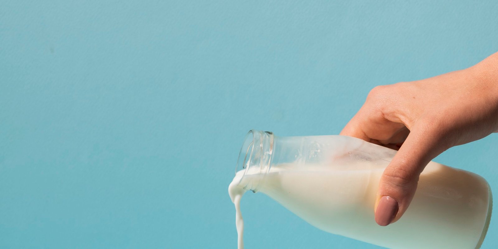 close-up-hand-holding-milk-bottle